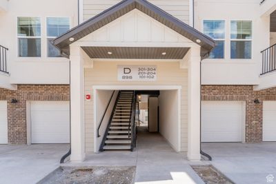 Doorway to property featuring a garage | Image 2