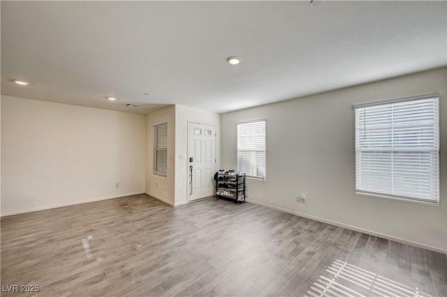 Empty room with wood finished floors and recessed lighting | Image 4