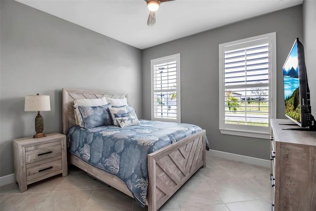 Bedroom #2 with Plantation shutters is in front of home | Image 8