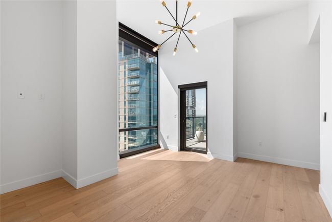 Spare room with a chandelier, hardwood / wood-style flooring, and baseboards | Image 26