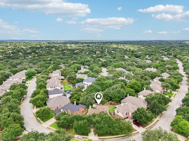 Situated on a spacious lot in a serene, tree-lined neighborhood. | Image 32