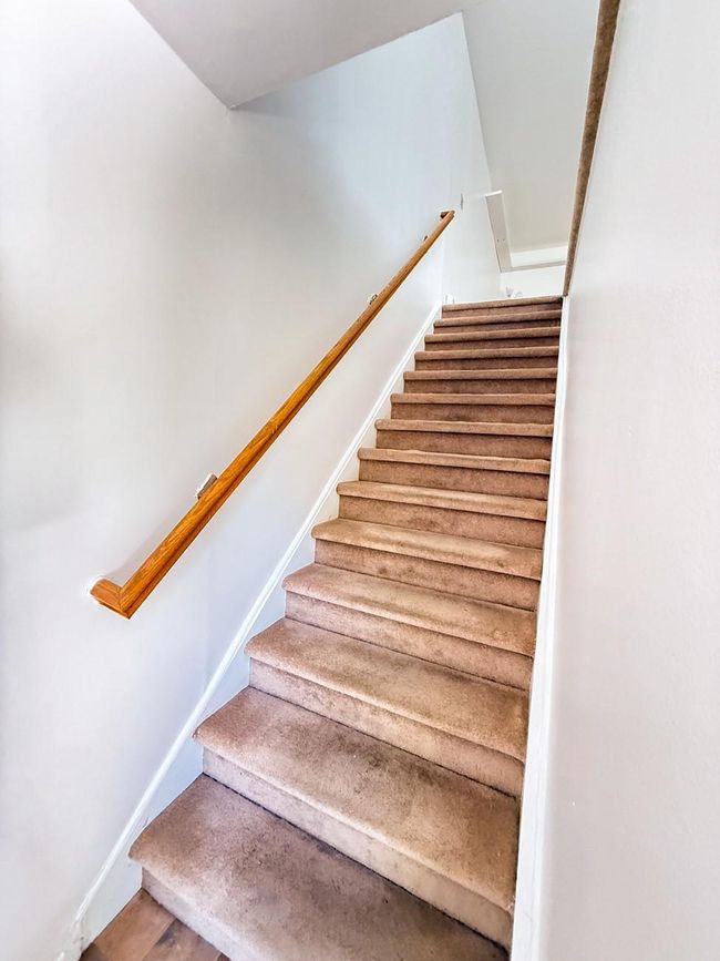Stairs leading up to unit with baseboards | Image 4