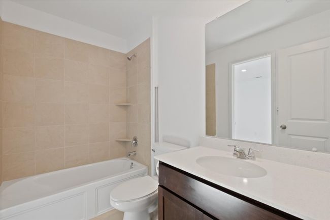 Full bath featuring toilet, vanity, and shower / washtub combination | Image 14
