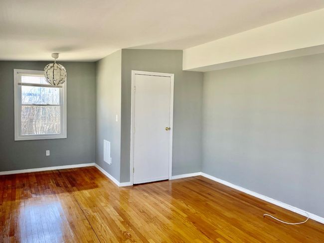 Unfurnished room with a chandelier, baseboards, and wood finished floors | Image 10