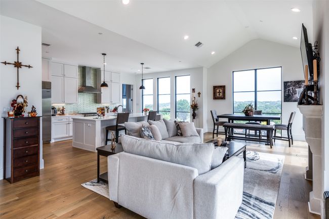 View of living room opens to kitchen with gorgeous views of trees and the city | Image 16