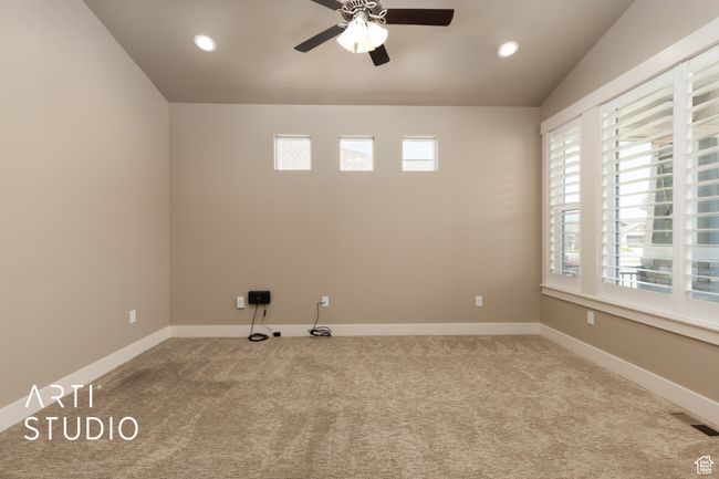 Spare room featuring a ceiling fan, carpet flooring, vaulted ceiling, and recessed lighting | Image 7
