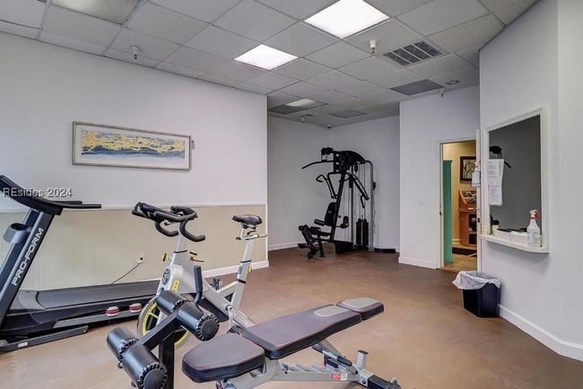 Workout room featuring a drop ceiling and concrete flooring | Image 21
