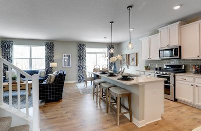 The kitchen is one of performance, and features granite countertops, tiled backsplash, rustic durable flooring, walk-in pantry and stainless steel appliances. Just an awesome set-up! *photo of model with same floor plan. Selections will differ. | Image 1