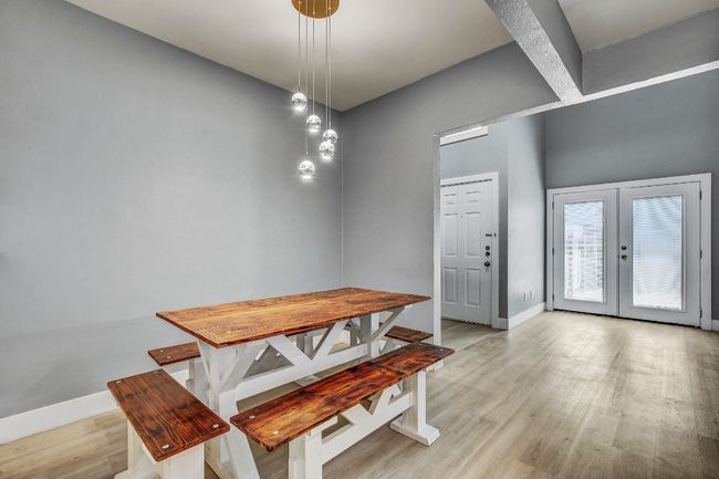 Dining room featuring light wood-type flooring, baseboards, and french doors | Image 9