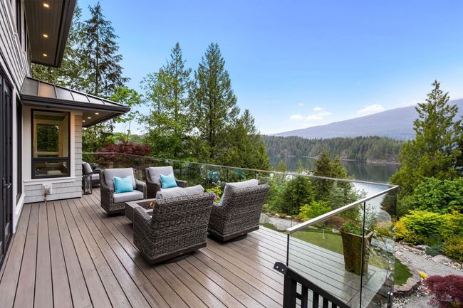 Deck with a wooded view and a water and mountain view | Image 30