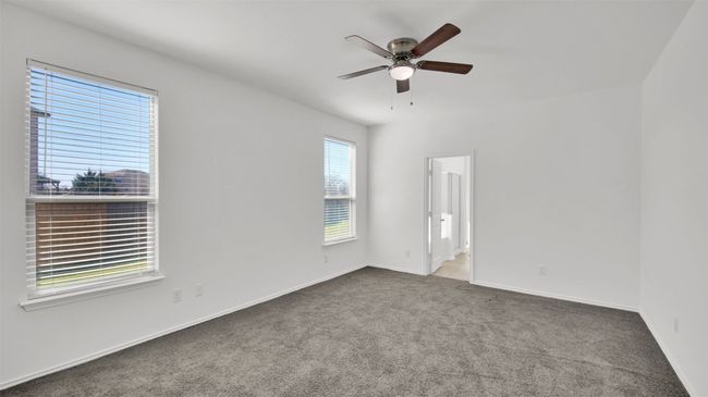 Unfurnished room with carpet flooring, ceiling fan, and baseboards | Image 20