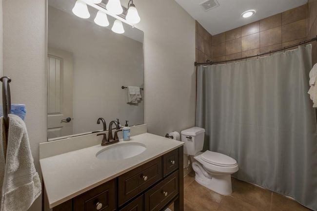 Designated full bathroom for fourth bedroom with tub/shower combination. Notice the tile goes all the way to the ceiling and the tub area has its own light | Image 28