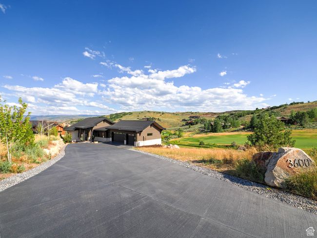 View of front facade featuring a garage, driveway, and a mountain view | Image 5