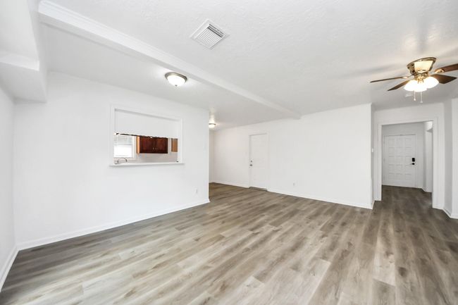 View from sliding door into kitchen pass-through window, formal dining area and breakfast room....with entrance to garage | Image 17