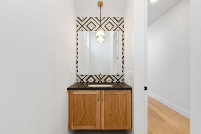 Bathroom featuring vanity, baseboards, and wood finished floors | Image 13