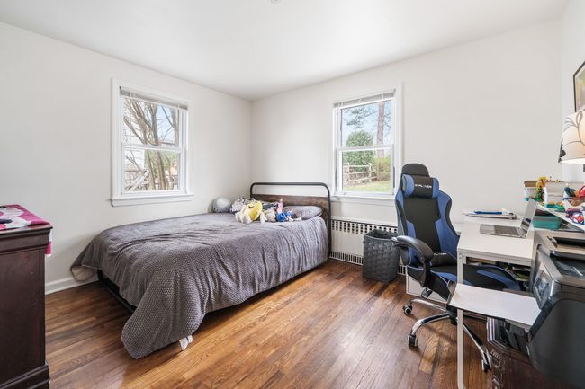 Bedroom featuring radiator heating unit and hardwood / wood-style floors | Image 17