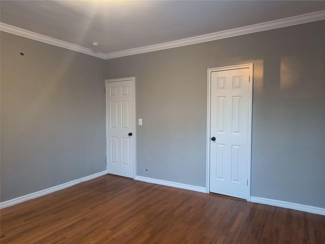 Empty room featuring baseboards, wood finished floors, and ornamental molding | Image 34