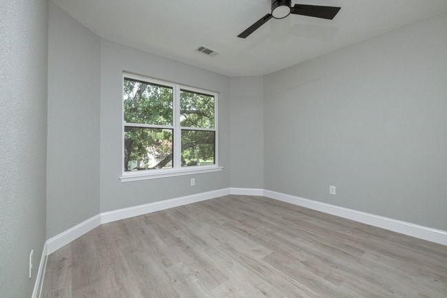 Spare room with light wood-style flooring and ceiling fan | Image 37