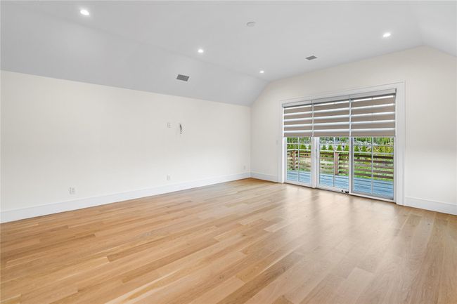 Unfurnished room with vaulted ceiling, baseboards, recessed lighting, and light wood-style floors | Image 33