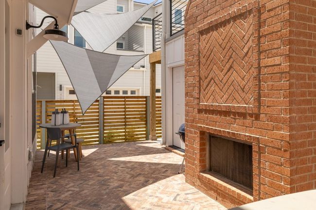 View of patio with an outdoor fireplace | Image 22