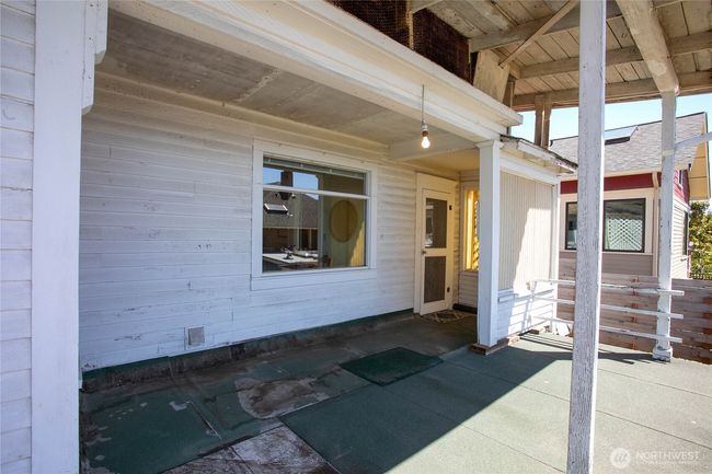 This door is from the enclosed porch leading to the front deck. The window here is from the kitchen area. | Image 31