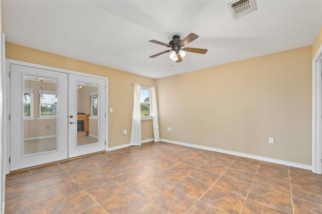 Unfurnished room with french doors, plenty of natural light, and ceiling fan | Image 22