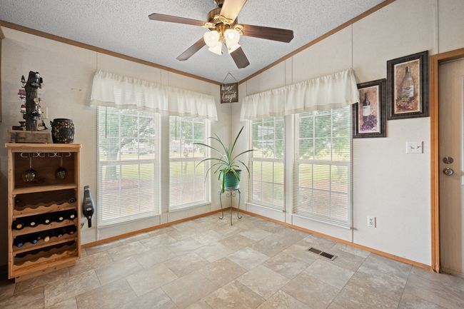 Lots of window and a beautiful view of the landscaped yard | Image 14