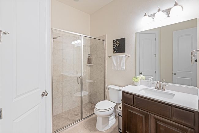 Full bath with vanity, a shower stall, and tile patterned flooring | Image 24