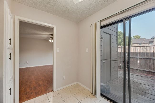 Unfurnished room featuring a textured ceiling, ceiling fan, and light tile patterned floors | Image 10