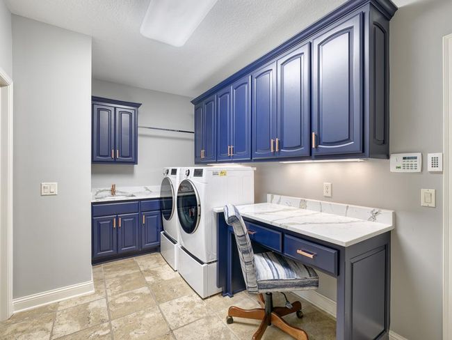 The main floor laundry room offers great storage! | Image 24