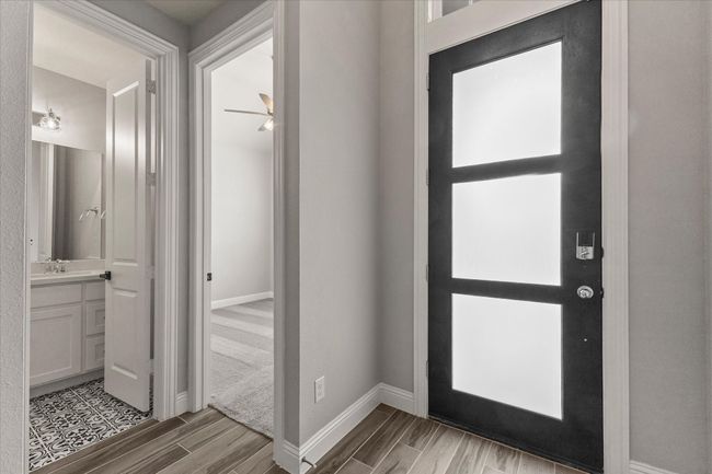 Foyer with wood finish floors and baseboards | Image 4