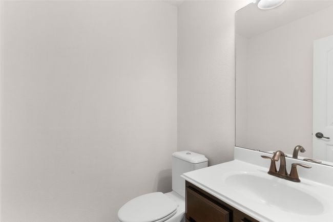 Bathroom featuring toilet and vanity | Image 38