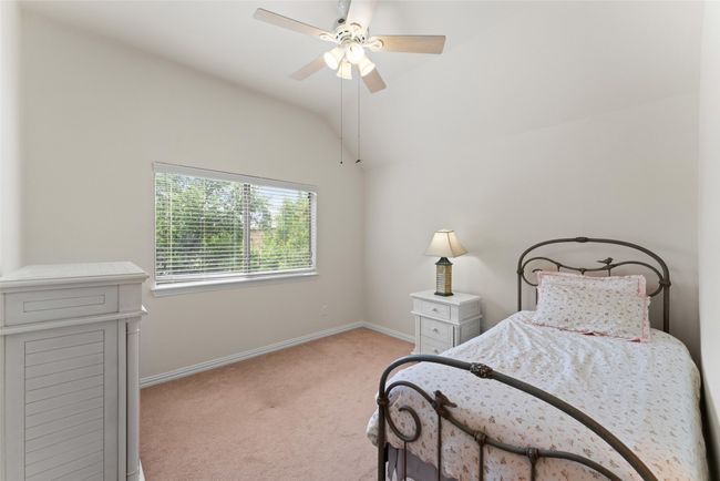 Carpeted bedroom with vaulted ceiling and ceiling fan | Image 27