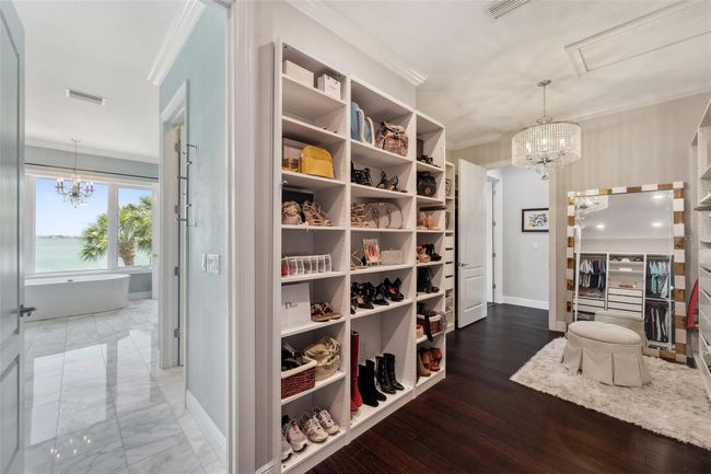 The master closet is accessible from both the master bathroom, as well as from the hallway just around to the left of the master bedroom. Oh, and have lots of shoes? No problem. | Image 55