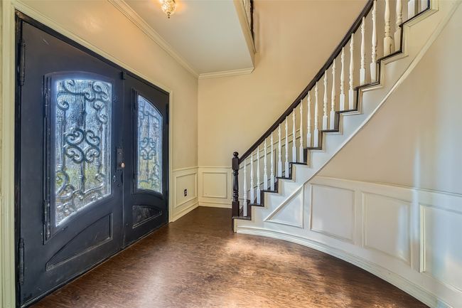 Enter your foyer with oversized doors and a grand staircase. | Image 14