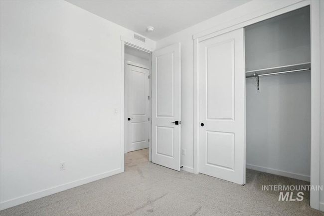 Unfurnished bedroom featuring light colored carpet and a closet | Image 17