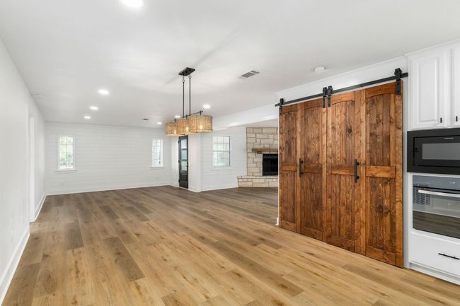 Spacious open-concept kitchen and dining area with elegant floors, perfect for entertaining. | Image 14