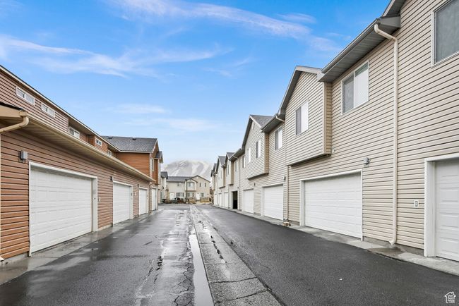 View of street with community garages and a residential view | Image 7