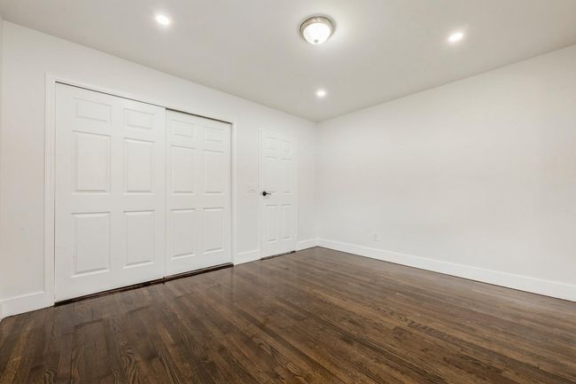Unfurnished bedroom with a closet, recessed lighting, dark wood-style floors, and baseboards | Image 6
