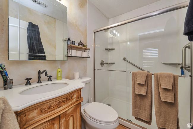 Full bath with vanity, visible vents, toilet, and a stall shower | Image 17