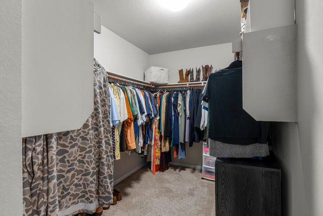 Walk in closet with carpet flooring | Image 17