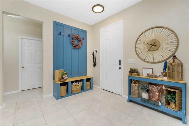 Front Door into large Front/Family RoomTwo guest rooms and a bathroom off the Front Room (door behind built-in hall tree) | Image 9