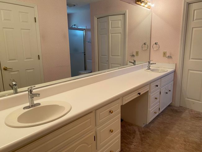 Owners Bath vanity with 2 separate sinks, also has large linen closet and walk-in closet | Image 18