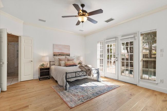 Primary bedroom with glass french doors to backyard | Image 13