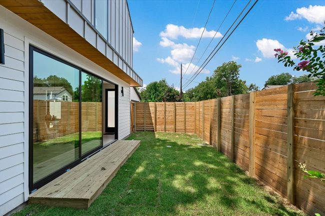 Fenced backyard with a deck | Image 25