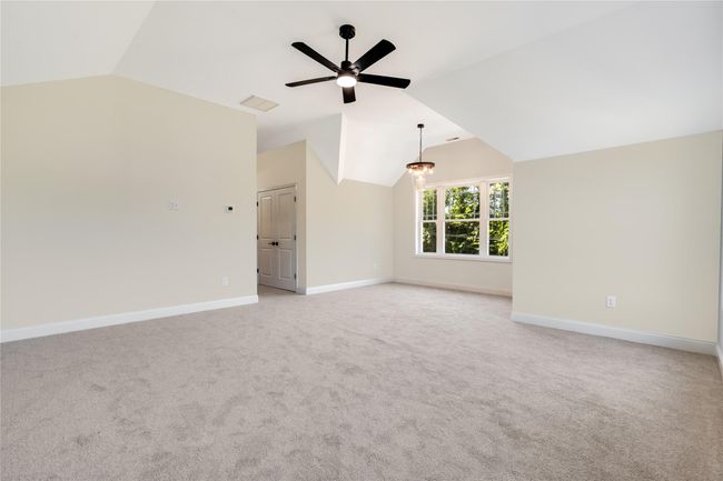 Empty room with light carpet and a tray ceiling | Image 21