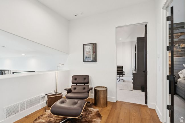 Sitting room featuring light wood-style floors, recessed lighting, and radiator | Image 65