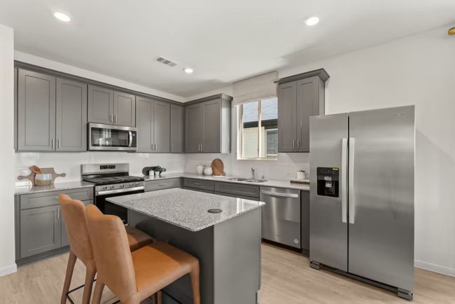 Photo of Pulte model home with same floor plan, not of actual home listed. | Image 5