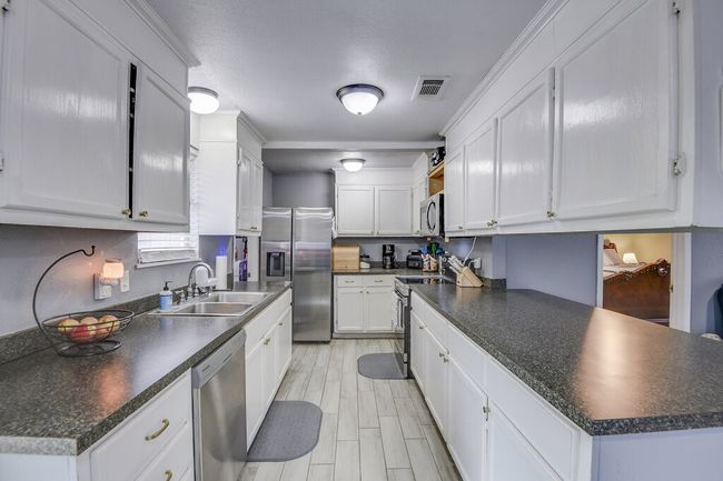 Galley style kitchen with so many storage options and great counterspace for meal prep! | Image 11