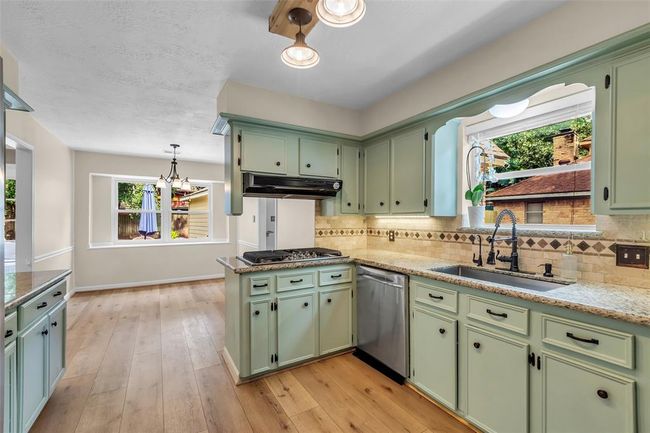 This angle from the breakfast room offers a clear view into the living room. | Image 21